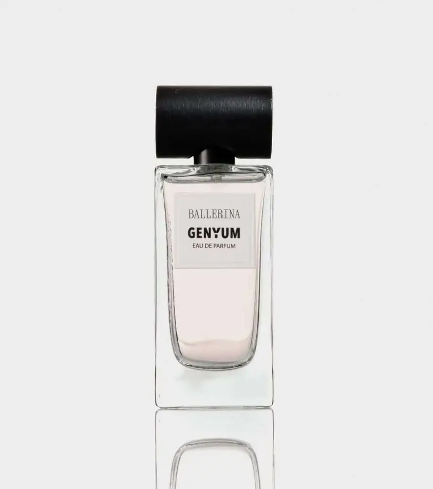 Clear glass perfume bottle of Genyum Ballerina with black cap, inspired by the grace of dance, showcasing the artistic fragrance collection.