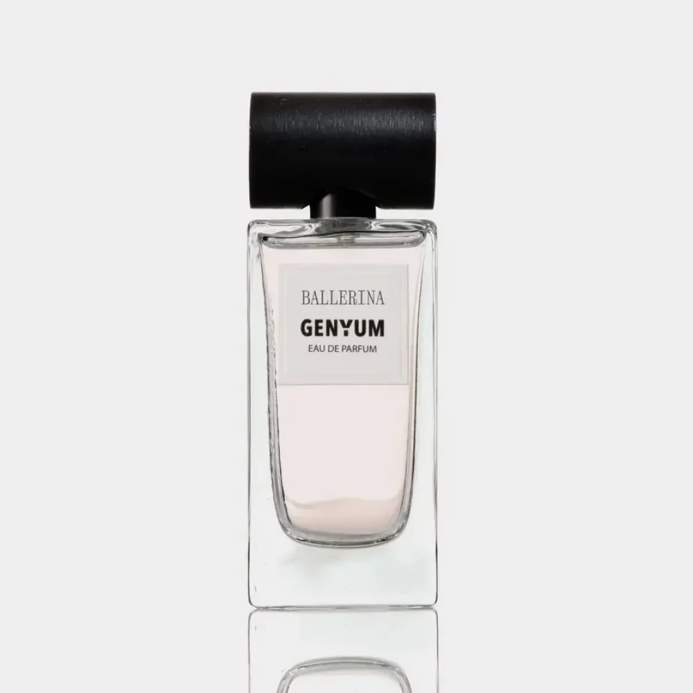 Clear glass perfume bottle of Genyum Ballerina with black cap, inspired by the grace of dance, showcasing the artistic fragrance collection.